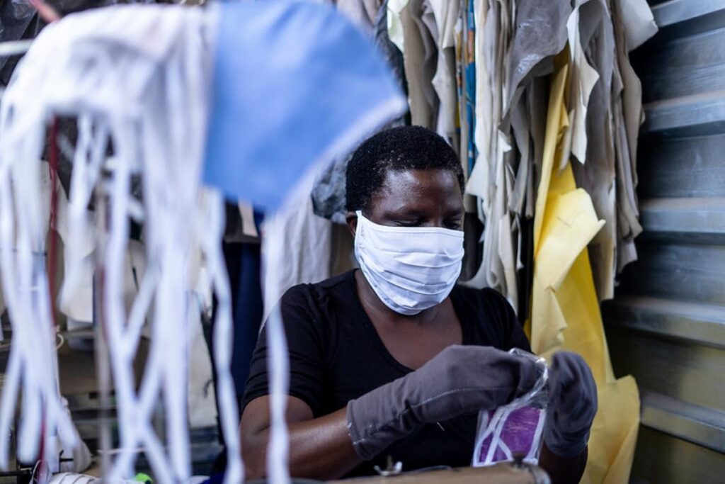 A woman working in a face mask manufacturing shop