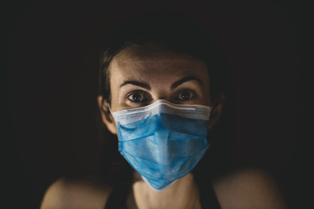 Woman wearing a blue surgical face mask