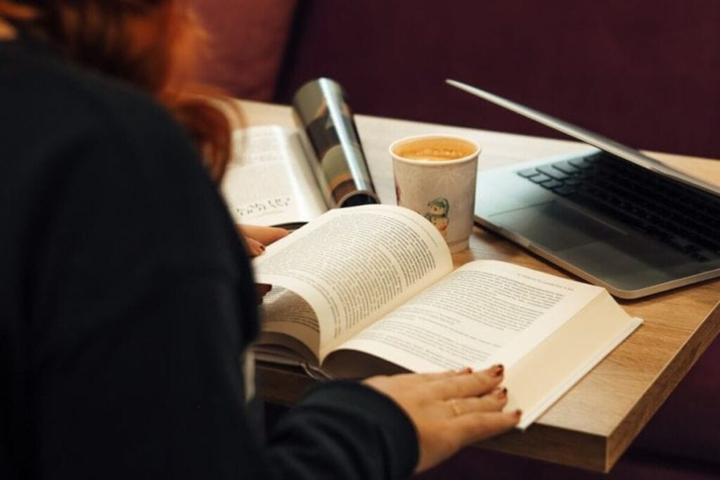 Someone reading devotedly through an open book