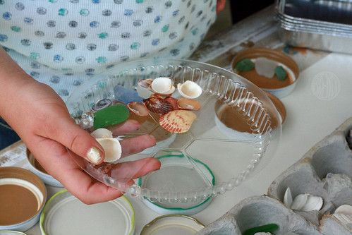 Woman adding decorative stones to make garden stepping stones