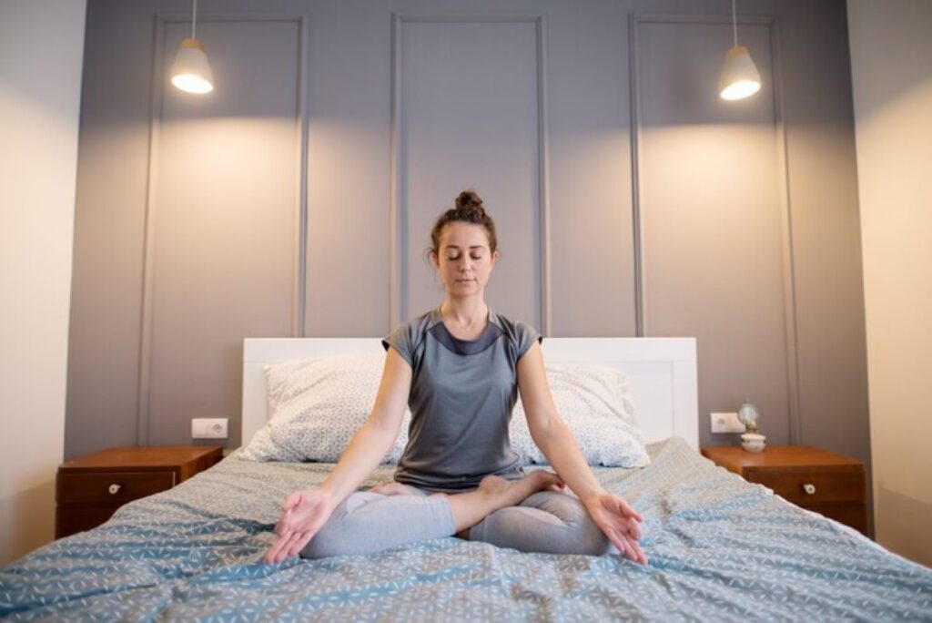 Young lady practicing yoga before going to bed