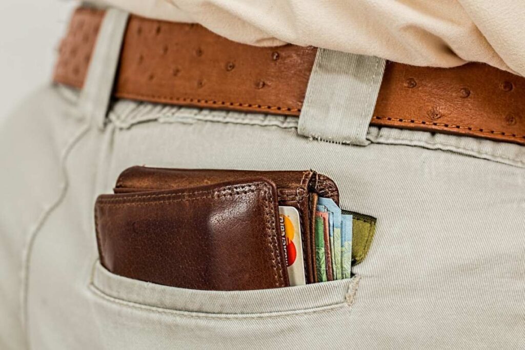 A brown wallet full of ATM cards