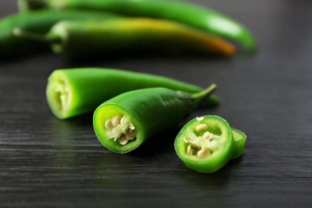 Whole green chilli pepper and diced pieces