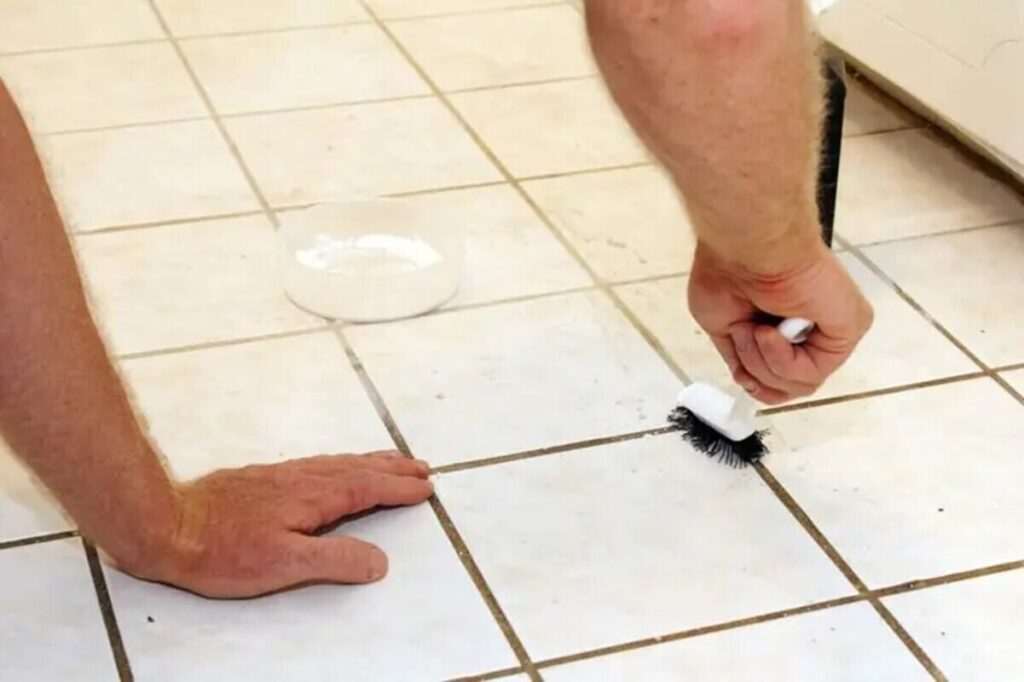 Cleaning grout with a brush and unlabelled solution