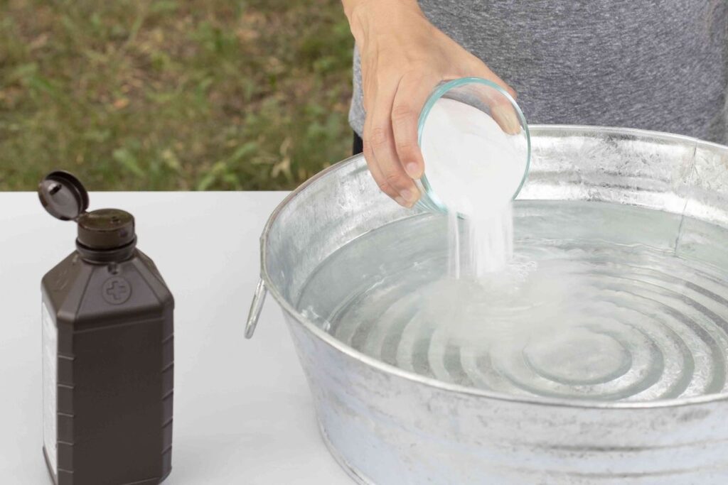 An image of a person pouring hydrogen peroxide into a bowl of water