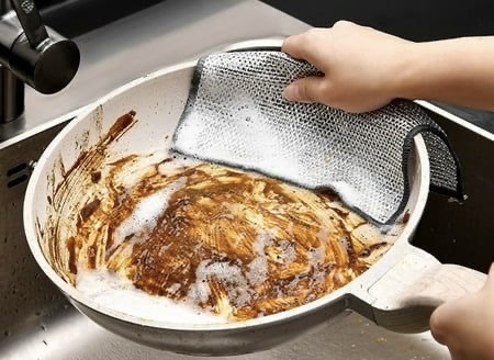 someone washing a pan