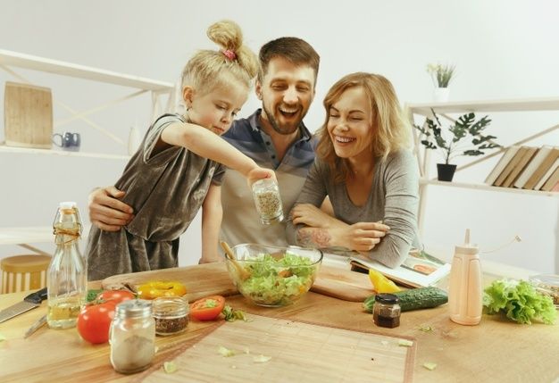 Parents and child making  breakfast 