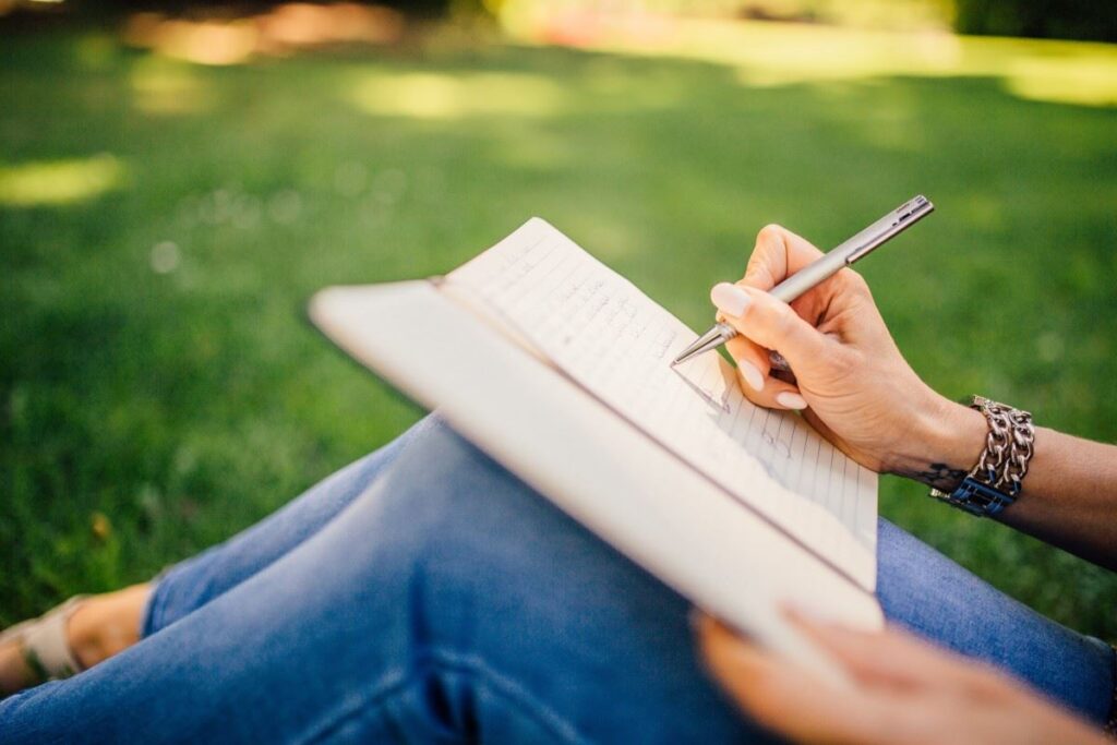 A lady journaling on a notepad