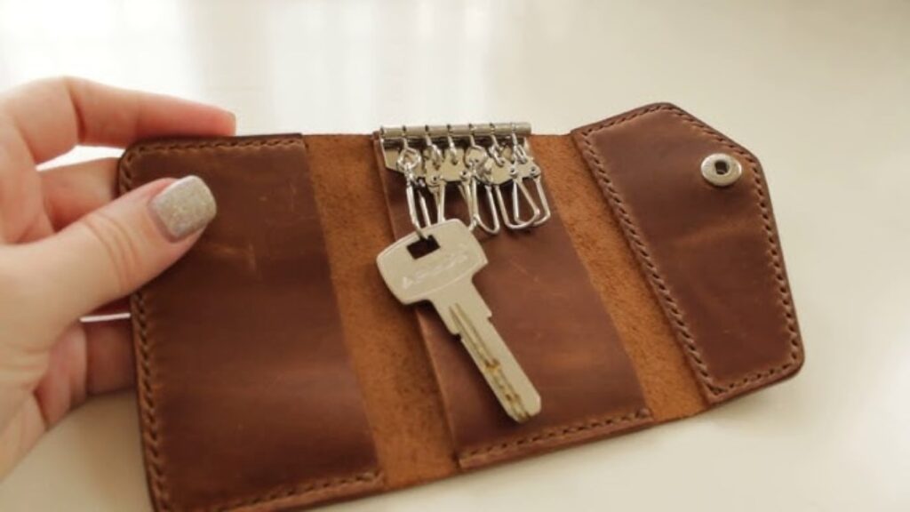 A brown leather wallet with multiple key notches