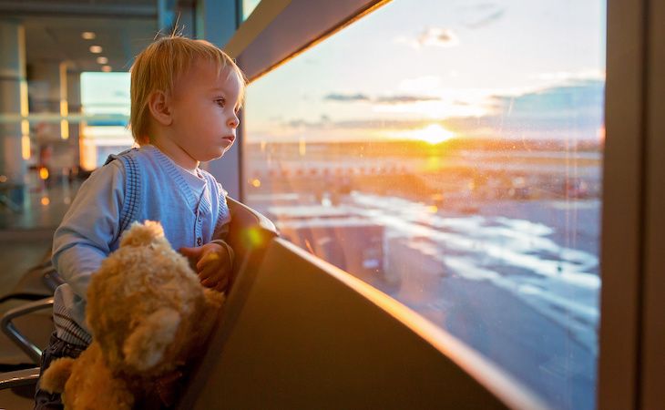 Child traveling together, waiting at the airport to board the aircraft