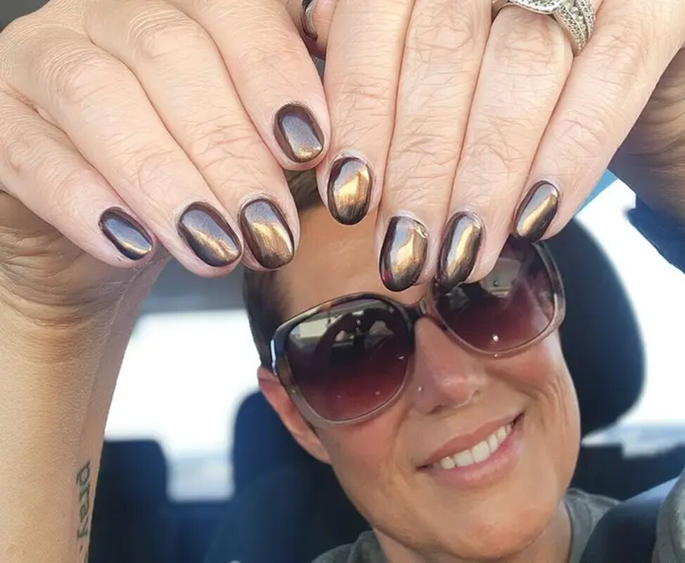 A woman showing off her newly done nail design