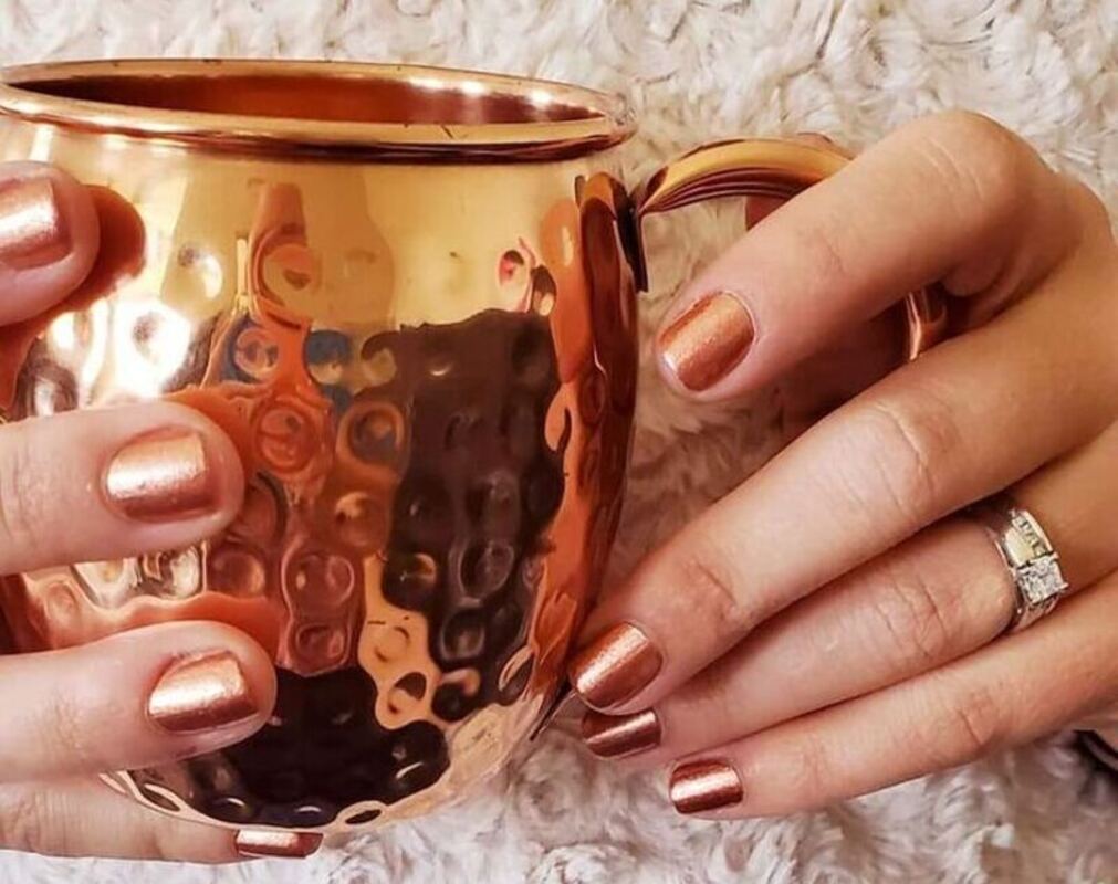 Comparing the metallic hue of the nail and the cup