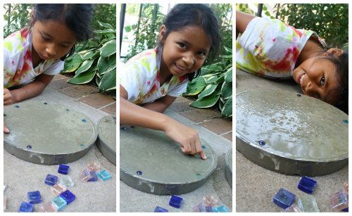 A young girl Picking the Perfect molds for making stepping stones