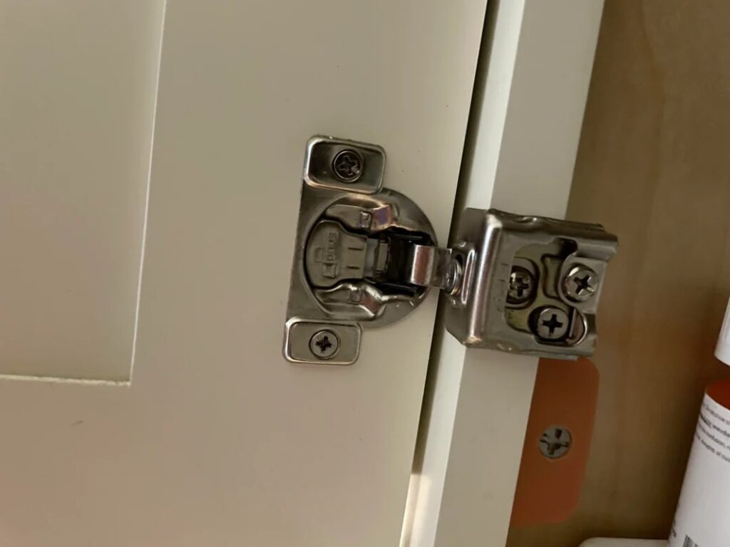 A newly installed cabinet hinge