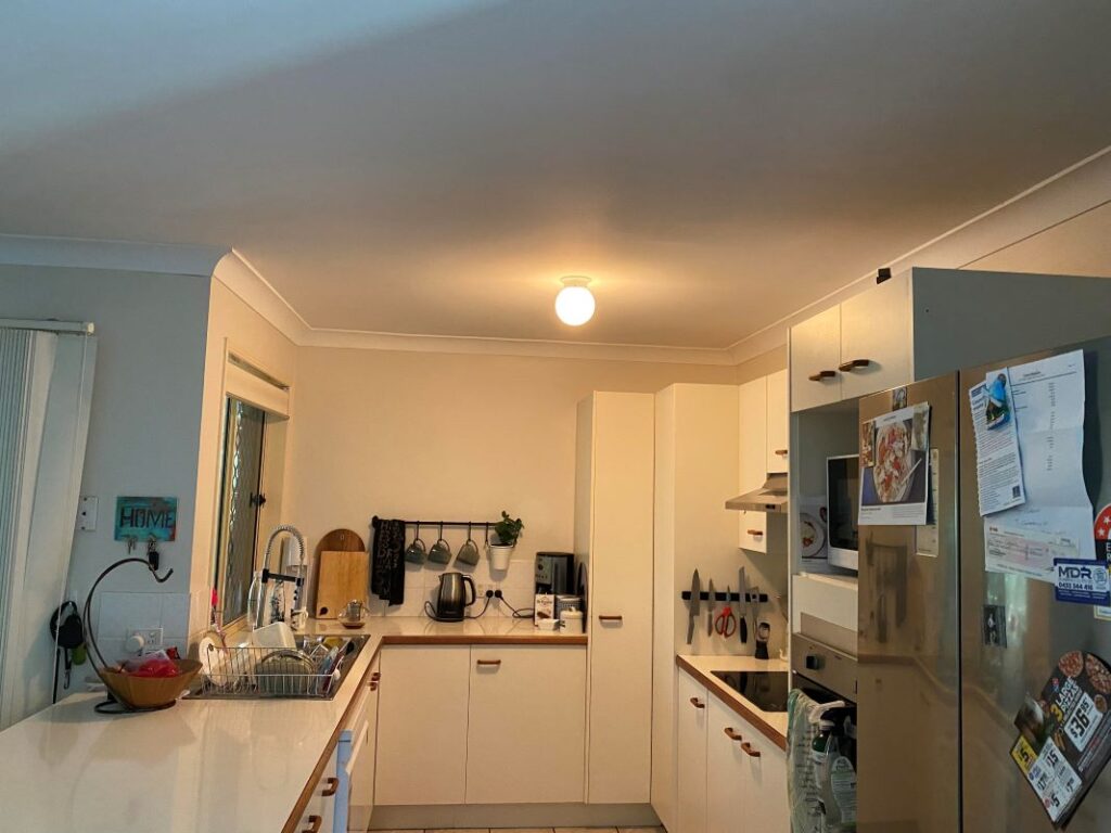 A kitchen with a single light source