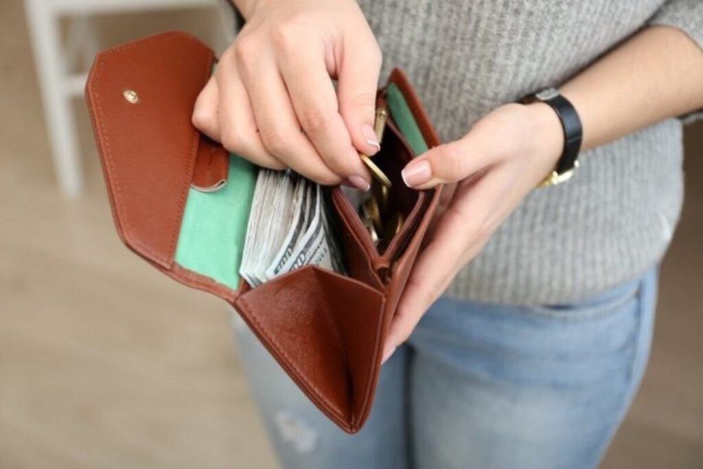 Woman with brown wallet and some items