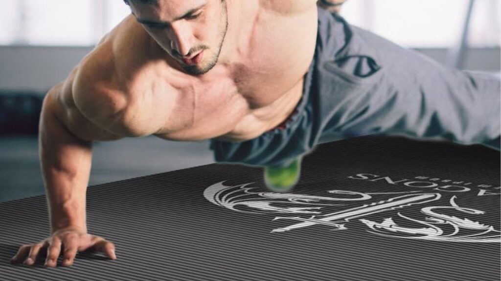 Man doing press up with one hand on a workout mat