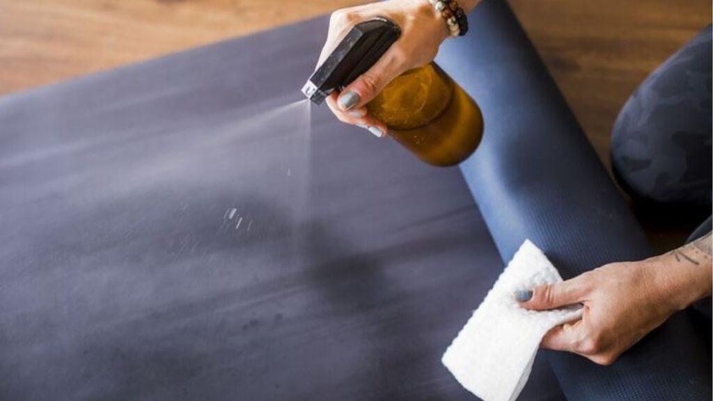 Woman cleaning a workout mat