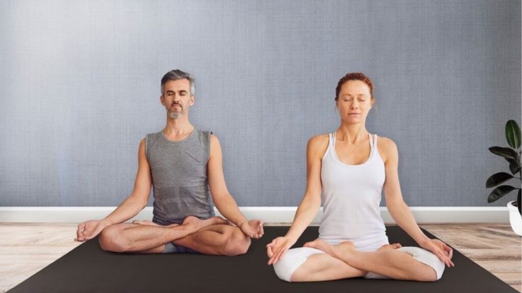 Couple having a yoga session on a workout mat