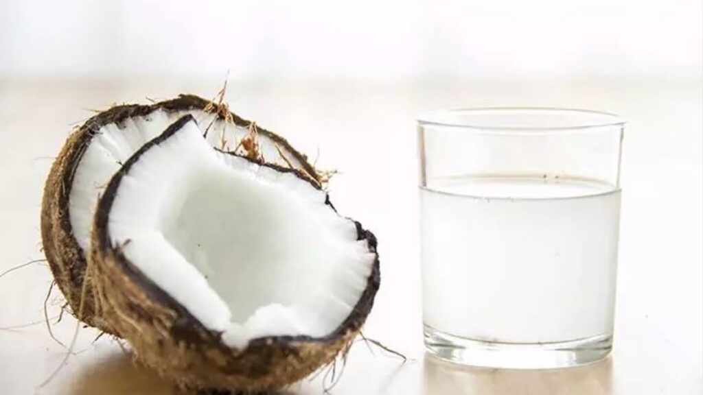 Broken Coconut and it's water in a glass