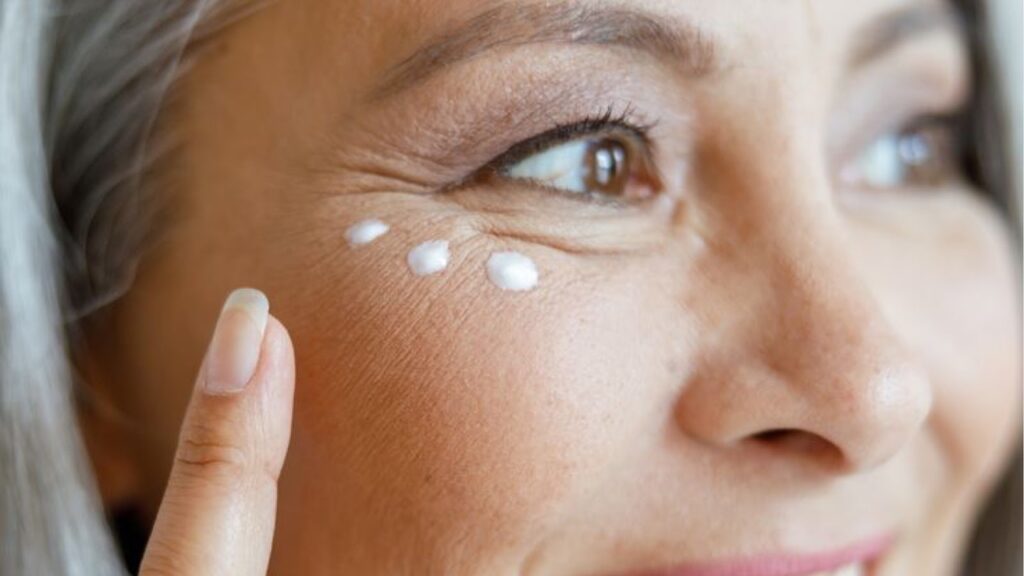 Woman applying eye cream