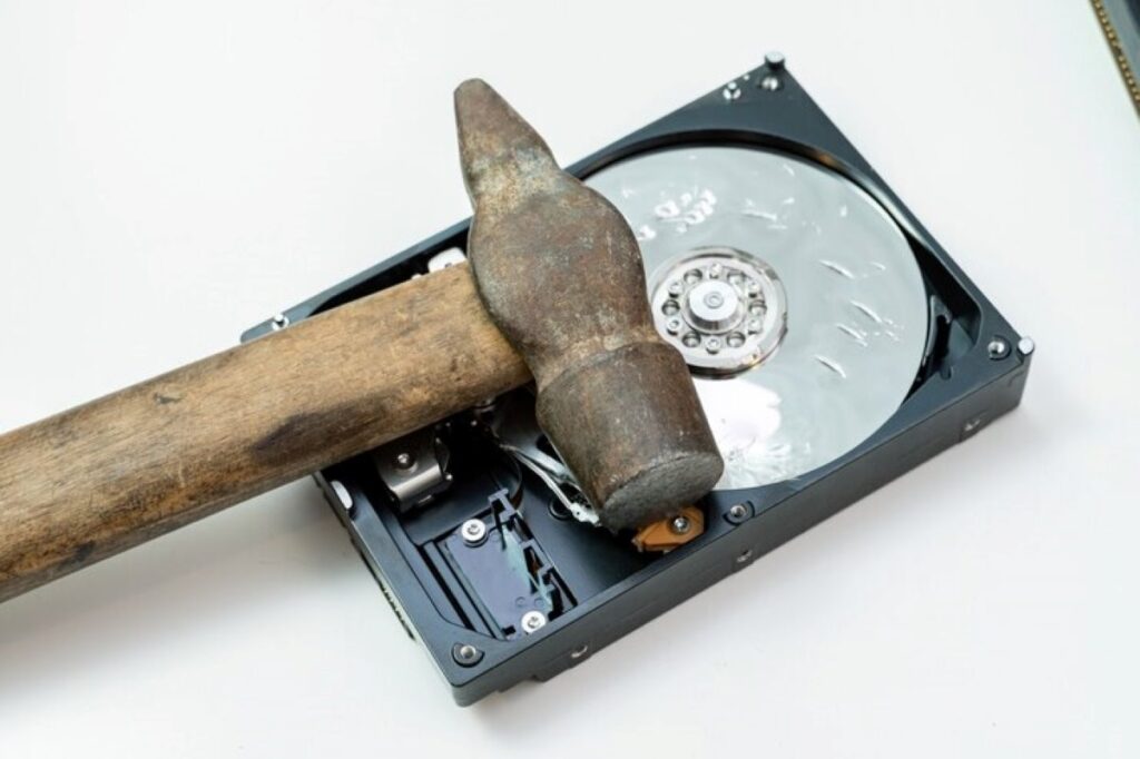 Destruction, deleting of data, information on a hard disk drive with a hammer