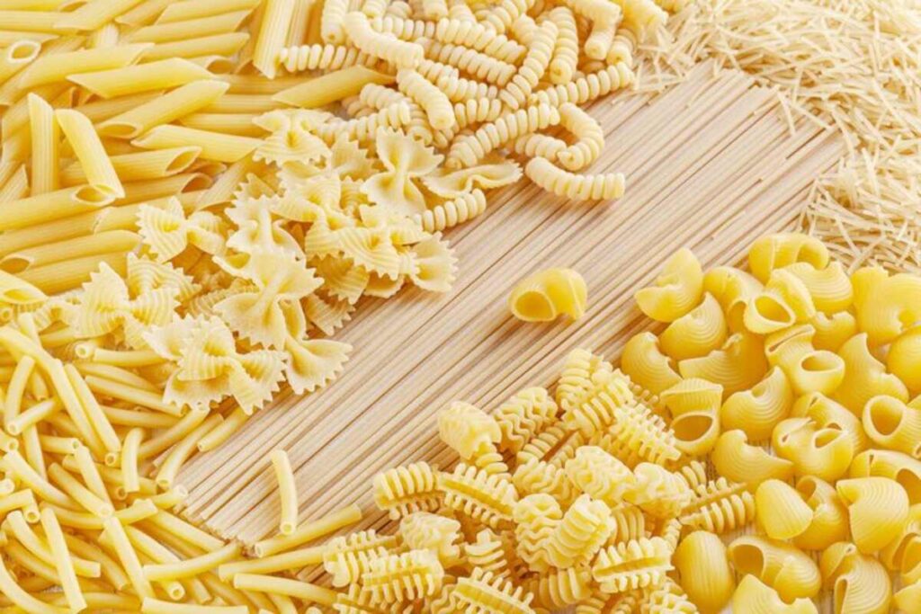 Different types and shapes of Italian pasta background