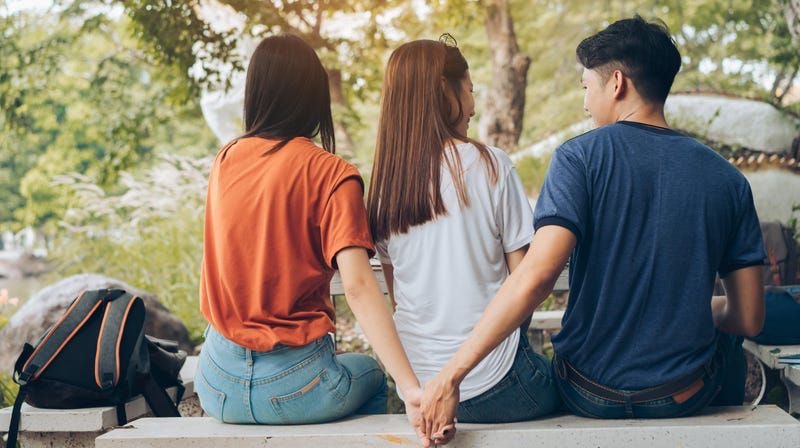 a man with two women