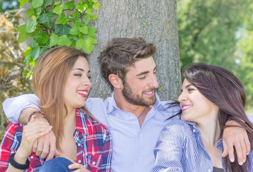 a man with two women