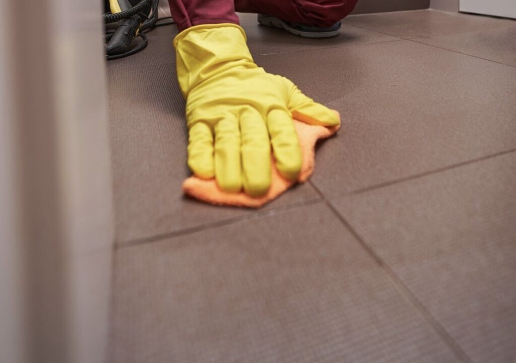 a person cleaning tiles