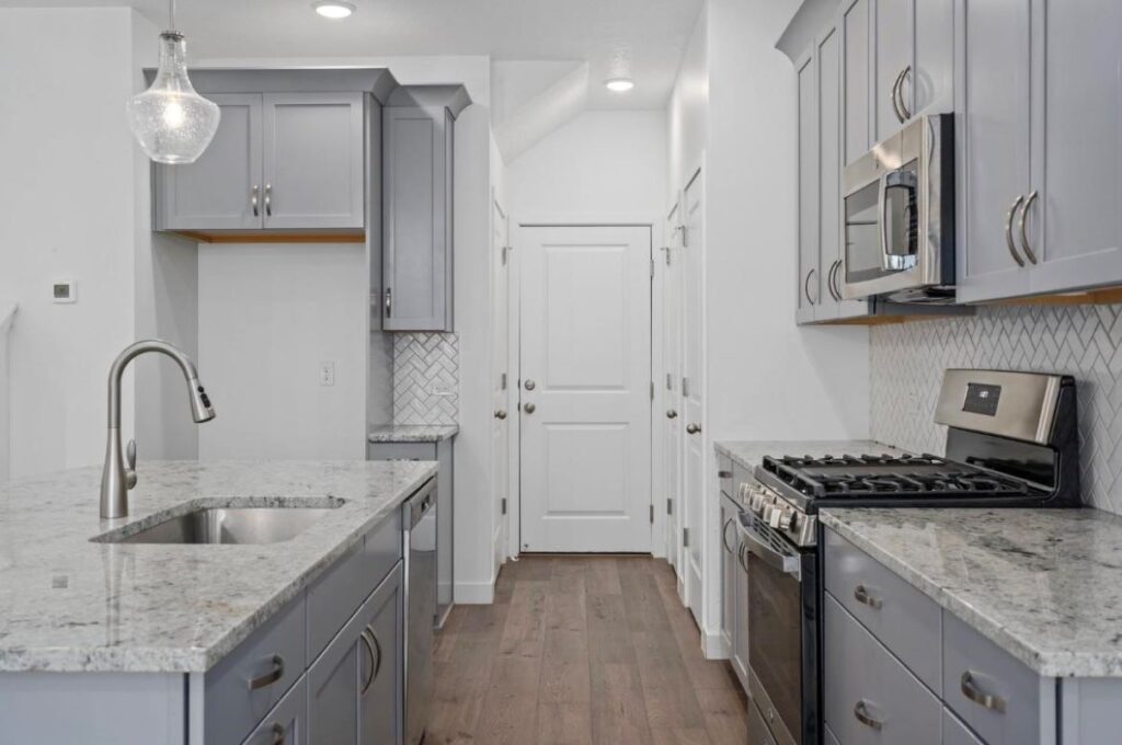 A kitchen with grey interior on walls and cabinets