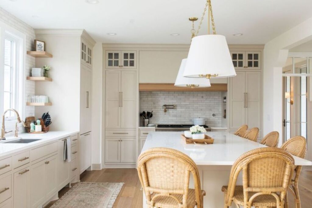 A home kitchen lavishly decorated with white paint and furniture