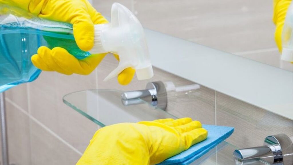 Person cleaning a bathroom