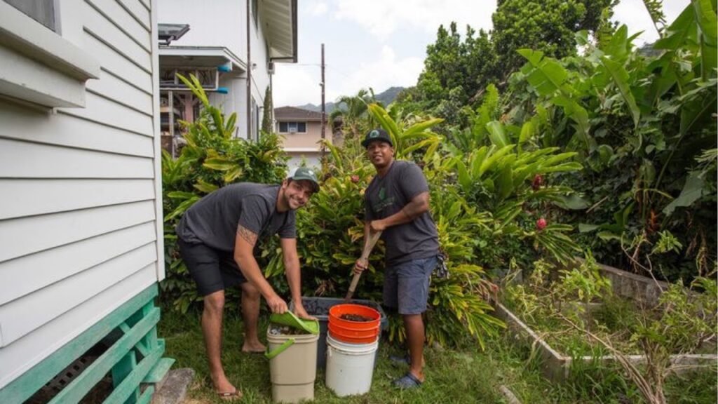 2 Men Adding Nutrient-Rich Compost to The Lawn