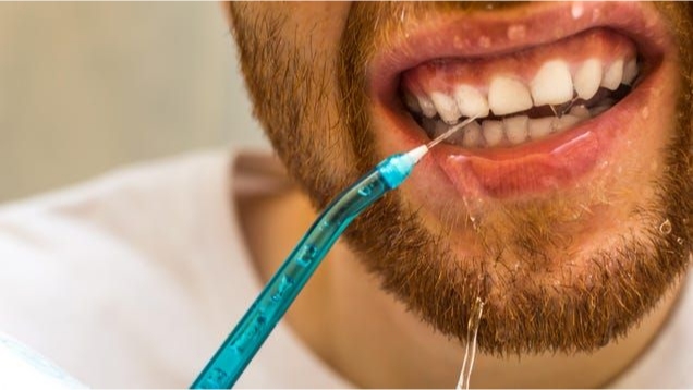 Use a Water Flosser to remove popcorn kernel from gum