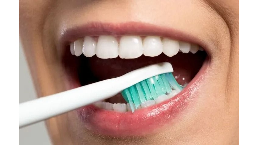 Brush with a Toothbrush at a 45-Degree Angle to remove popcorn kernel from gum