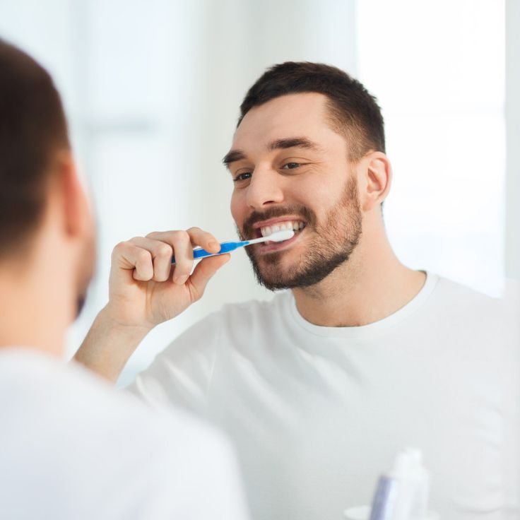 a man brushing teeth